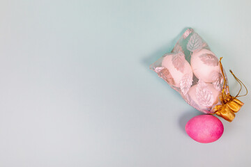 Easter. White eggs with a red egg in a bag on a uniform blue background.