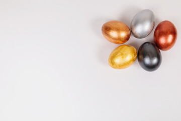 Multi-colored eggs on a uniform white background with place for text.