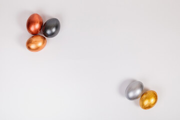 Multi-colored eggs on a uniform white background with place for text.