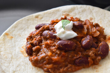 rice withChilli con carne with Greek yogurt and coriander on Tortillas. Mexican food. meat