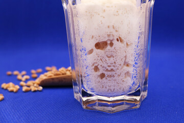 Wheat natural leaven for bread in a glass jar. The concept of a healthy diet. Sourdough starter. A living product. Grains. Selective focus.