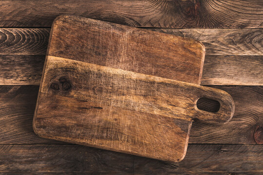 Rustic Cutting Board On Wooden Table. Overhead View.