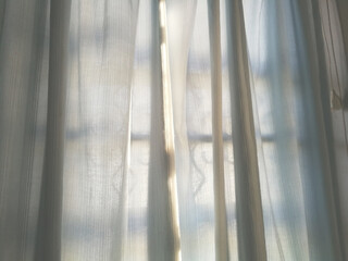 Full frame shot of transparent curtain and soft light of the sun from window to bedroom.