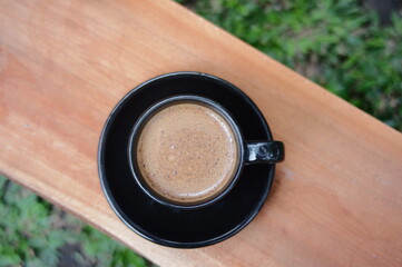 cup of coffee on wooden table