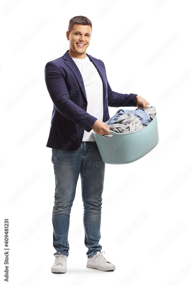 Wall mural Full length portrait of a young man holding a full laundry basket