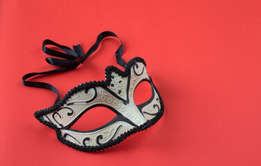 masquerade mask on a red background
