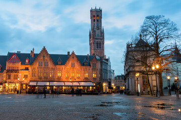 Fototapeta na wymiar Burg Square at sunset with puddles after the rain. Bell Tower in the background. Bruges, Belgium.