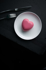 pink heart-shaped mousse cake on a plate