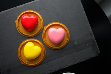 red, yellow and pink heart-shaped mousse cake