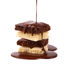 Porous chocolate pieces and chocolate syrup, isolated on white background. Black and white aerated chocolate.
