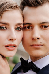 beautiful, gentle and happy bride and groom. man gently touches woman's face