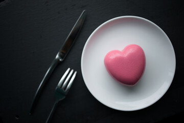 pink heart-shaped mousse cake on a plate