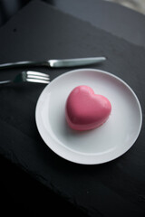 pink heart-shaped mousse cake on a plate