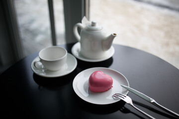 pink heart-shaped mousse cake on a plate