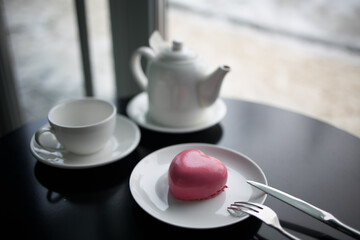 Obraz na płótnie Canvas pink heart-shaped mousse cake on a plate