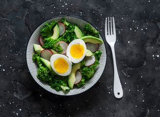 Kale, avocado, radish, cucumbers, olive oil salad and soft boiled egg - delicious healthy...
