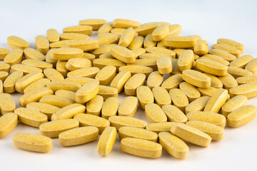 Orange pills on white background. Health, complex vitamins people. Health care. Nutritional supplements, vitamins. Health, multivitamins. Taking medication, pills. Close-up. Immunity
