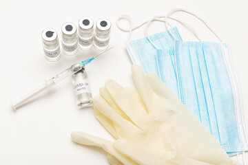 Bottles with coronavirus vaccine, developed for protection against COVID-19, healthcare syringe,...