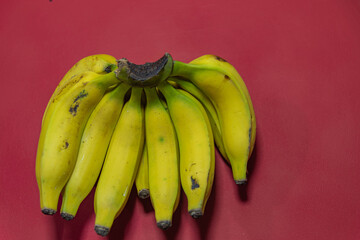 Bunch of yellow bananas on red background