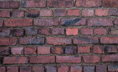 old rustic brick wall with different red colours 