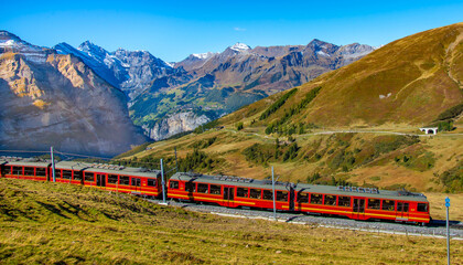 Plakat Red train is climbing to Jungfraujoch. Switzerland. 