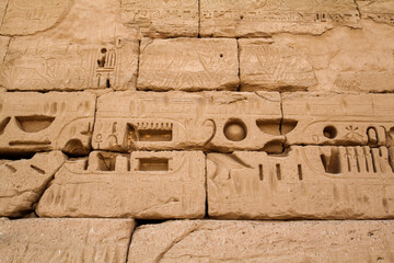 Ancient hieroglyphs on the temple wall of Medinet Habu, Thebes