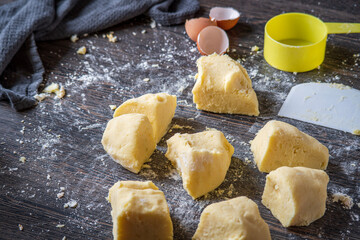 Italian gnocchi preparation steps: Homemade gluten free mashed potato puree dough divided into...