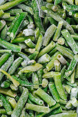 Green beans laid frozen covered with sticky powdered ice. top view. Cut in short pieces.