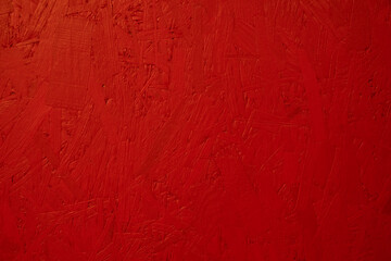 Bright red wooden background wall. Painted OSB board texture. Small budget construction...