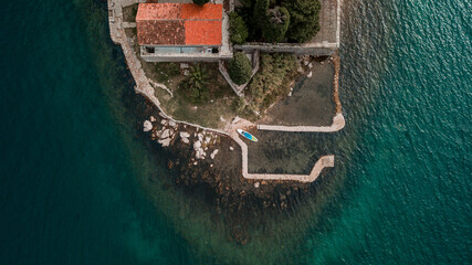 Aerial view with SUP stand up paddle board  at Our Lady of the Rock island and Church in Perast on...