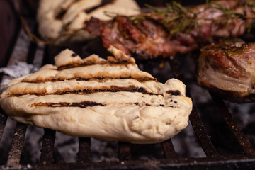 grilled meat with roasted fire rosemary and bread dough tortilla cordoba argentina