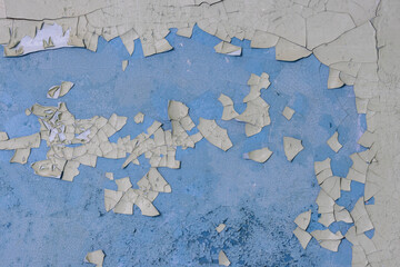 Peeling paint on the wall. Old concrete wall with cracked flaking paint. Weathered rough painted...