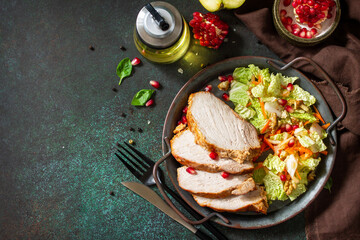 Healthly food. Baked meat steak salad and Chinese cabbage salad with apple, pomegranate, walnuts and on a stone tabletop. Top view flat lay. Copy space.