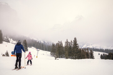 Father and daughter skiing