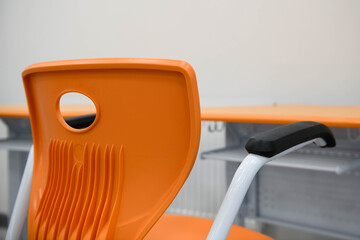 Modern bright school / office furniture - orange armchair.