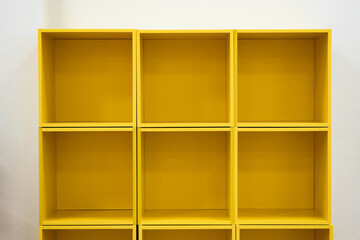 Open yellow storage shelves, empty.