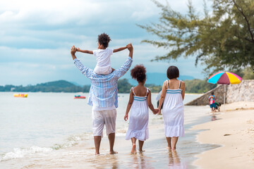 Happy African American family with African American father / asian mother and mixed race kids...