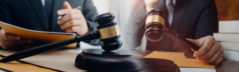 Business and lawyers discussing contract papers with brass scale on desk in office. Law, legal services, advice, justice and law concept picture with film grain effect