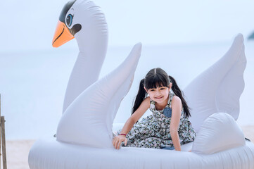 Happy smiling girl lying on fancy swimming ring, summer vacation and relax concept