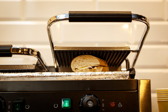 Sandwich Toaster With Toast And Ingredients.