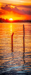 Fototapeta na wymiar Pôr do sol na lagoa, nuvens coloridas em tons de laranja