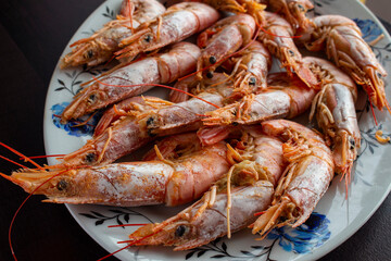 Fresh and delicious seafood, cooked shrimps. Whole cooked tiger prawn on dish.Selective focus.