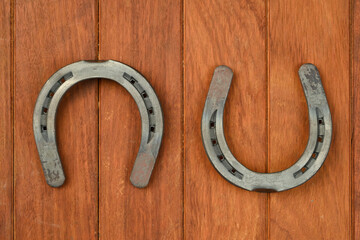 Saint patrick's day concept. Horseshoe of luck on wooden background, top view place 