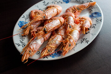 Fresh and delicious seafood, cooked shrimps. Whole cooked tiger prawn on dish.Selective focus.