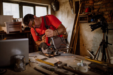 Fototapeta na wymiar Craftsman cutting metal and using angle grinder