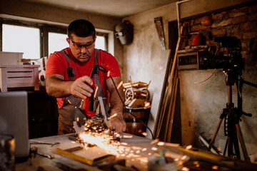 Craftsman cutting metal and using angle grinder