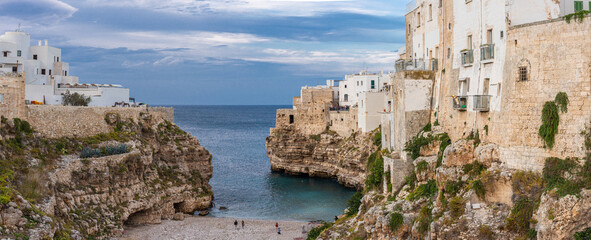 Fototapeta na wymiar The beach of Polignano a Mare with its steep cliffs of the old town