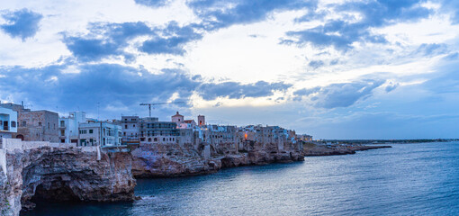Fototapeta premium Sunset by the sea in Polignano a Mare in Puglia, Italy
