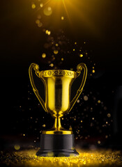 Golden trophy on black background in rays of light.