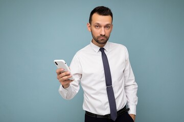 Handsome good looking brunet unshaven man with beard wearing casual white shirt and tie isolated on...